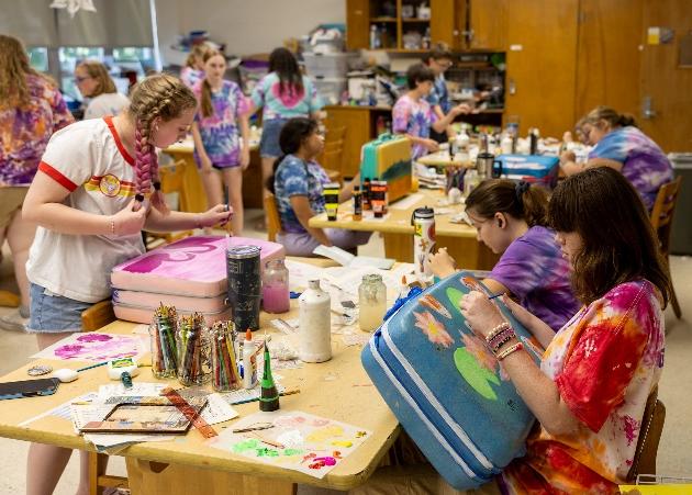 Art Camp students decorating luggage